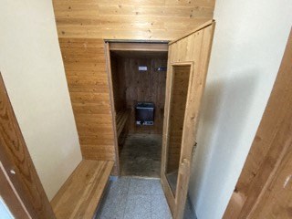 a view of a hallway with wood paneling and a tv
