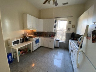 a kitchen with a stove and a microwave and a sink