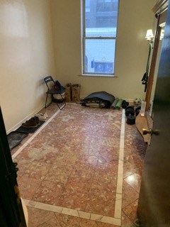 a living room with a tiled floor and a window