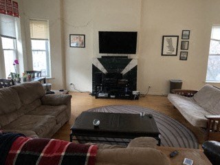 a living room with couches a coffee table and a television