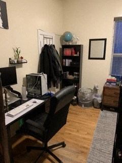 a desk with a computer and a chair in a room