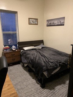 a bedroom with a bed and a window