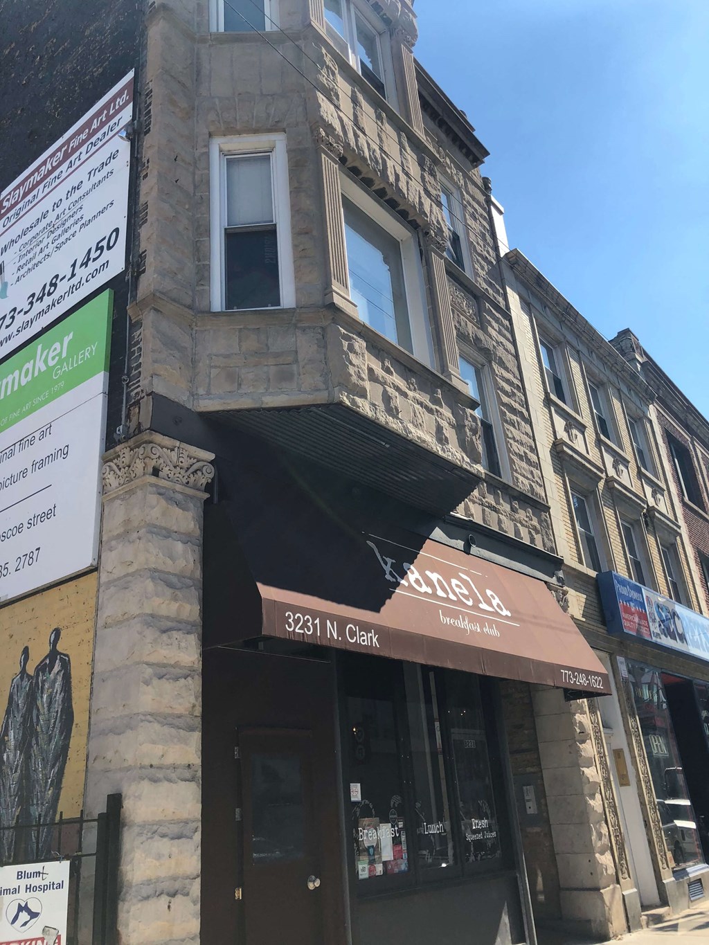 a building with awning on the corner of a street