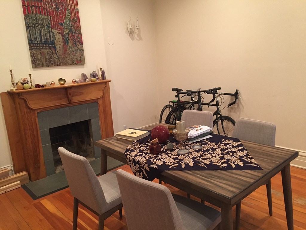 a dining room with a table and chairs and a fireplace