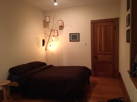 a bedroom with a bed and a wooden door