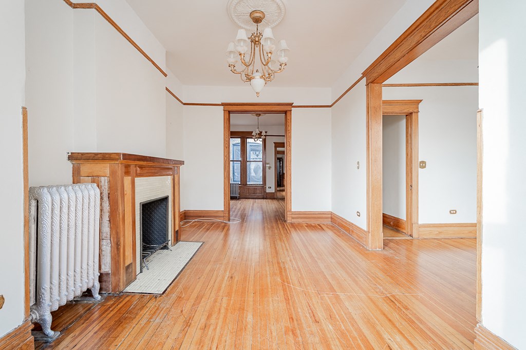 a living room with wood floors and a fireplace
