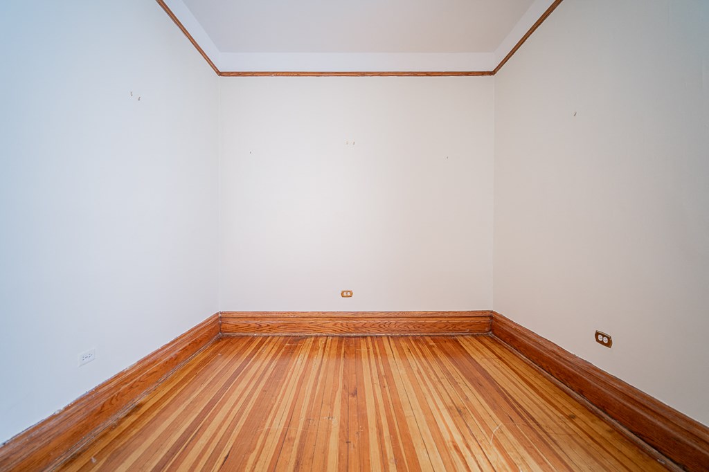 a empty room with wood floors and white walls