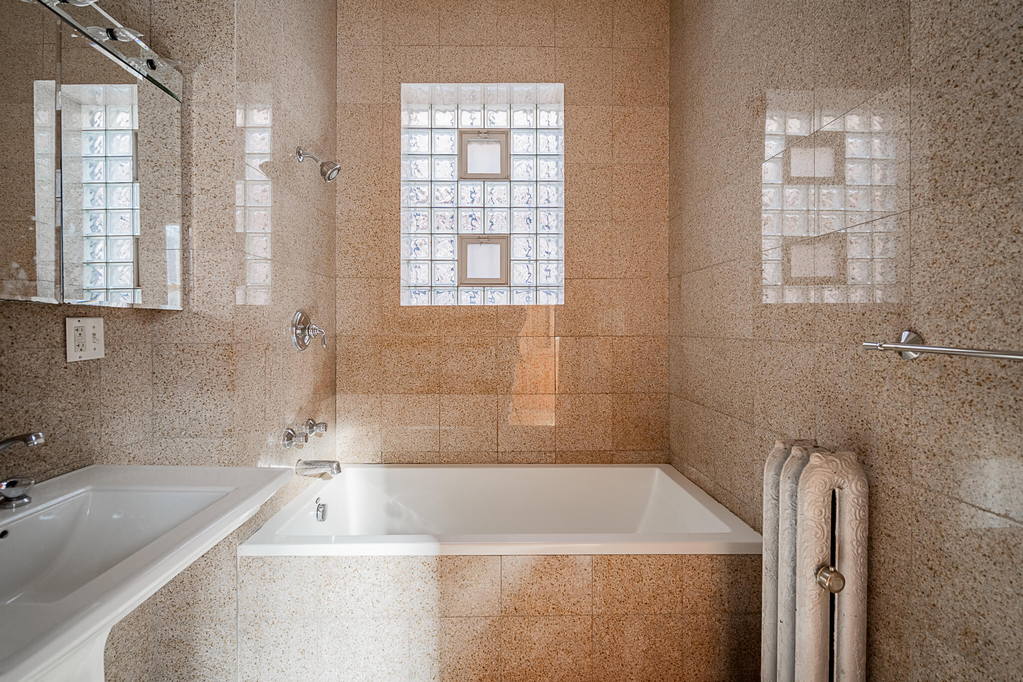 a large bathroom with a tub and a sink