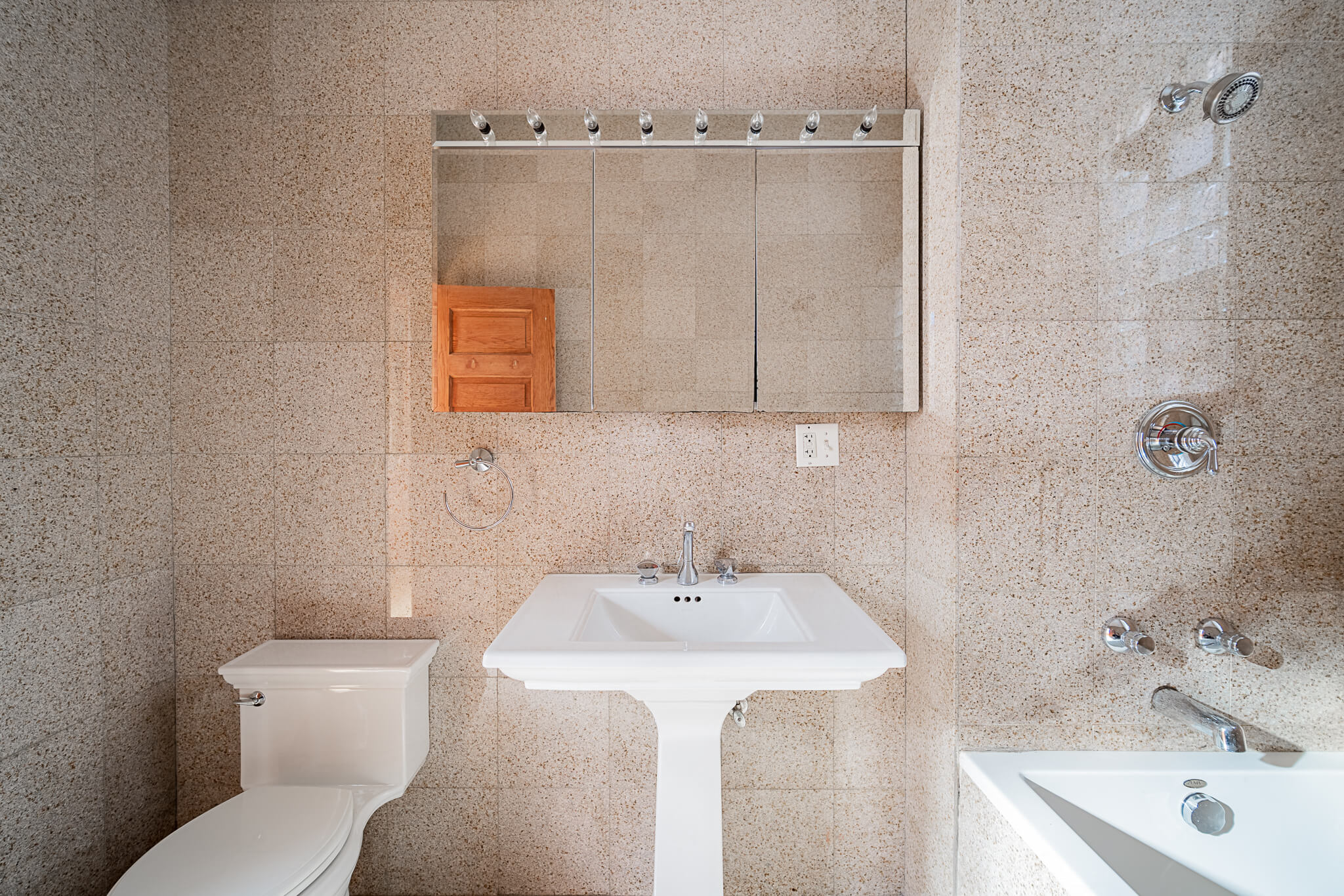 a bathroom with a sink toilet and a mirror