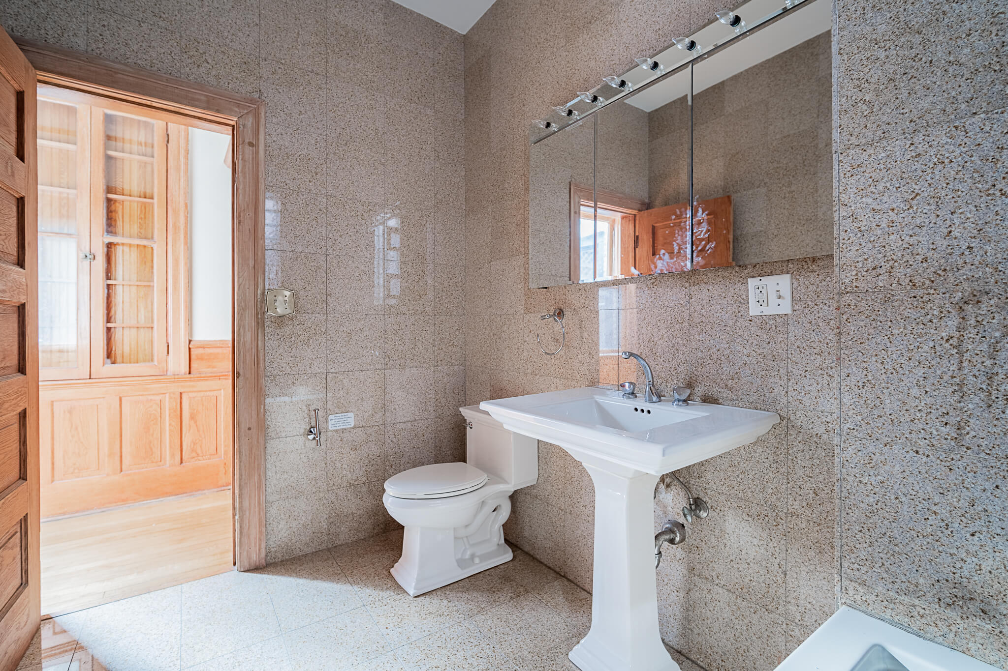 a bathroom with a toilet sink and a mirror