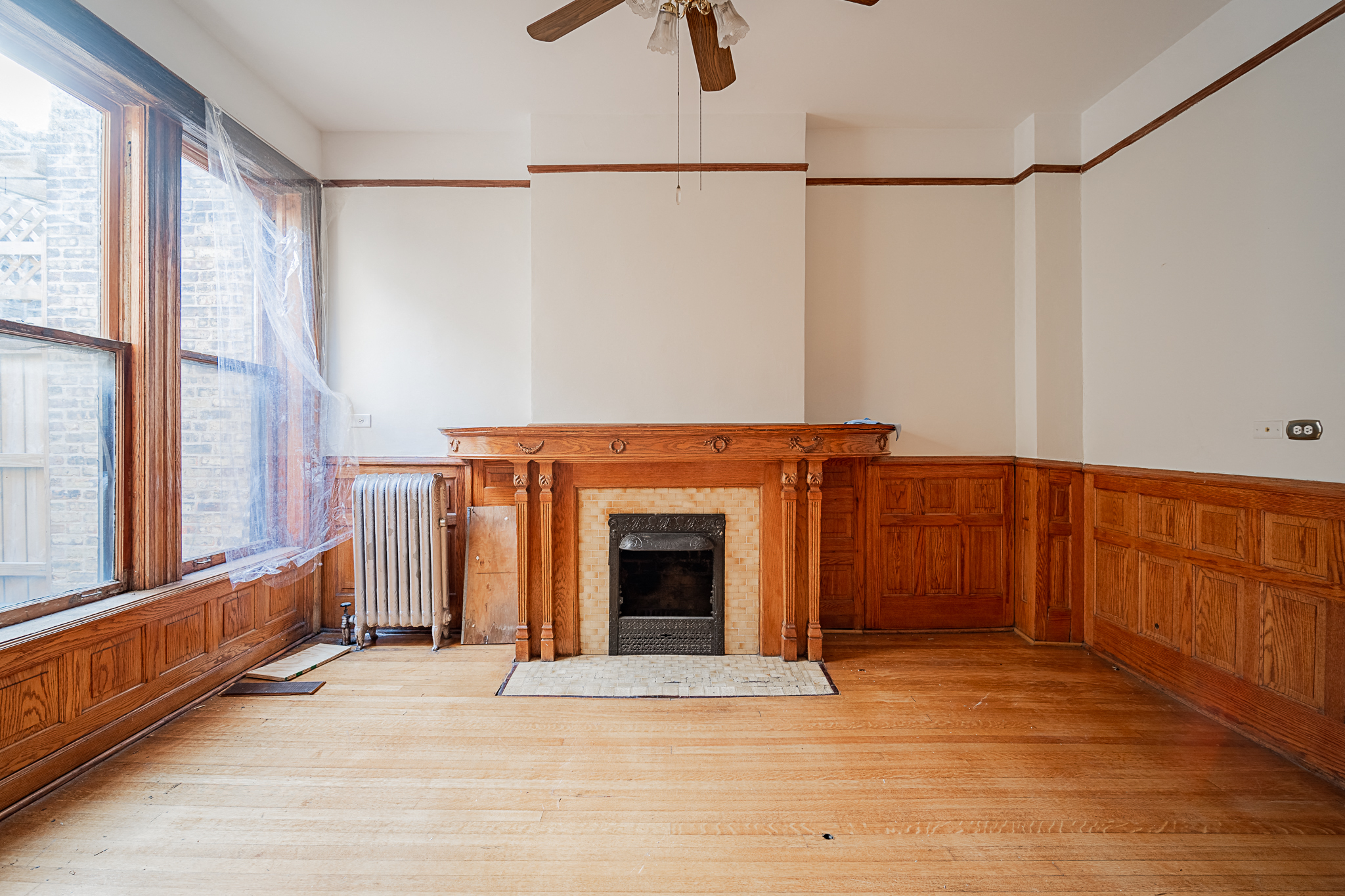 a living room with wood paneling and a fireplace