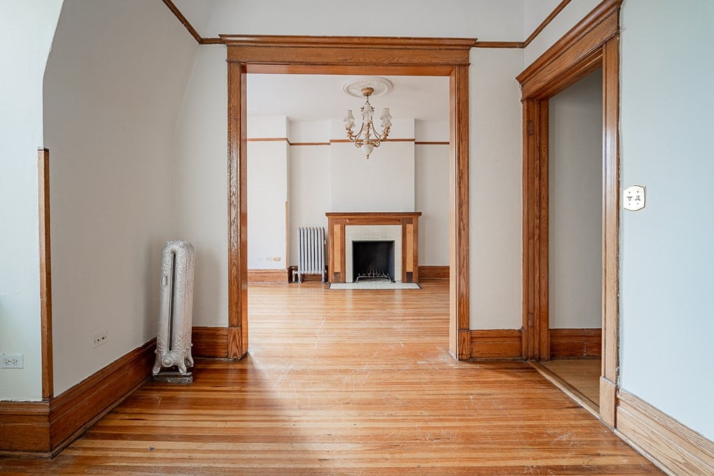 a living room with wood floors and a fireplace
