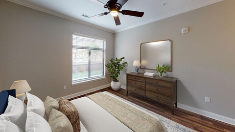 A living room with a white couch and a wooden dresser.