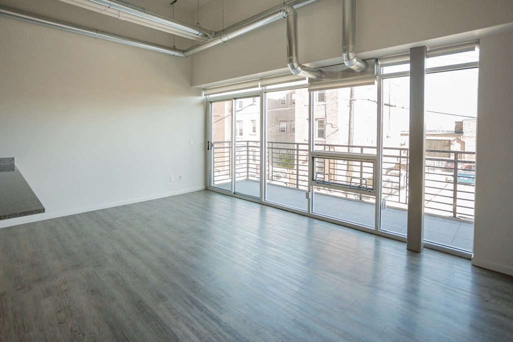 A room with a large window and a view of a cityscape.