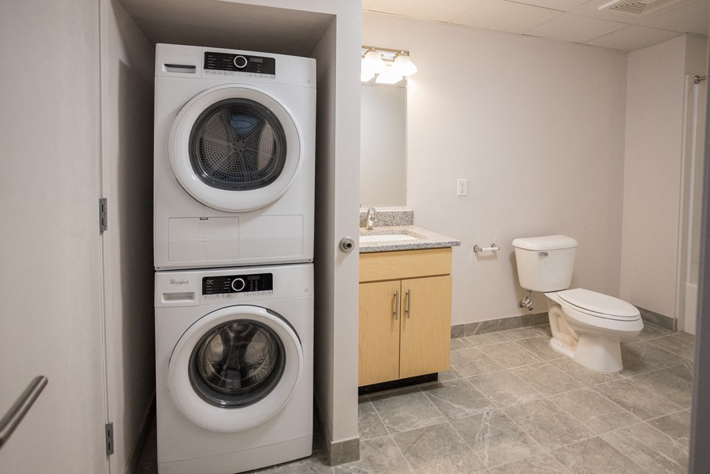 A white washer and dryer in a small laundry room.