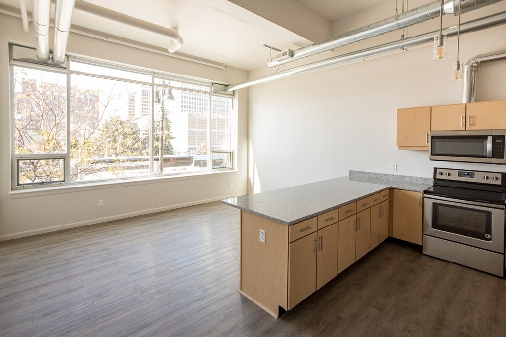 A kitchen with wooden cabinets and stainless steel appliances.