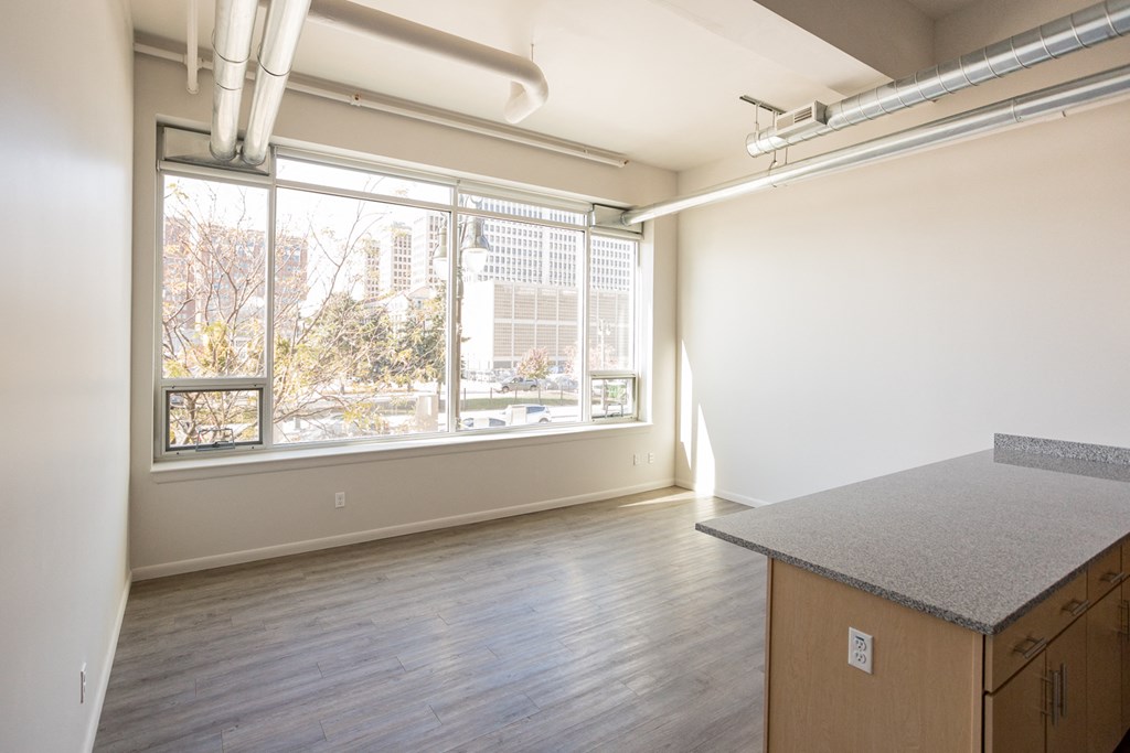 A room with a window overlooking a cityscape.