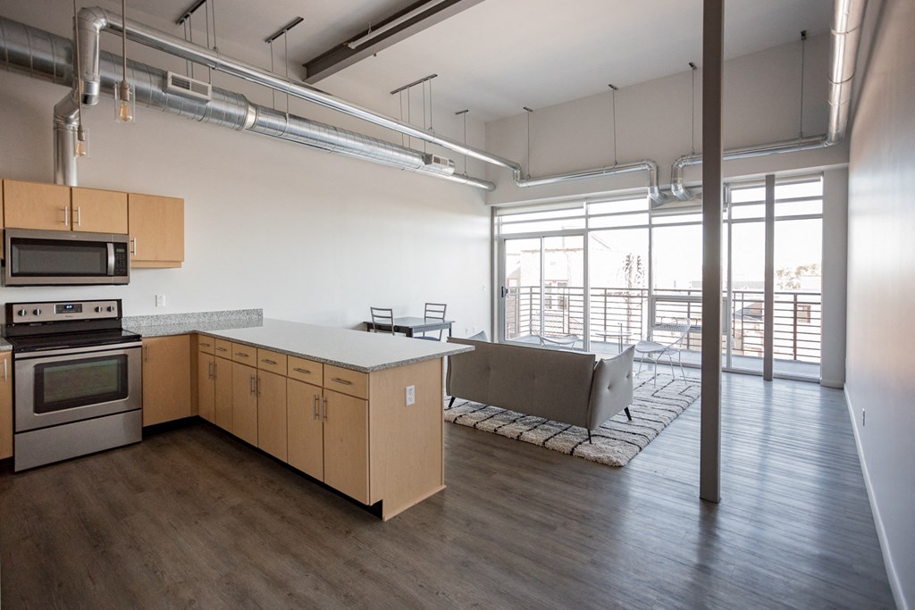 A kitchen with wooden cabinets and a stainless steel oven.