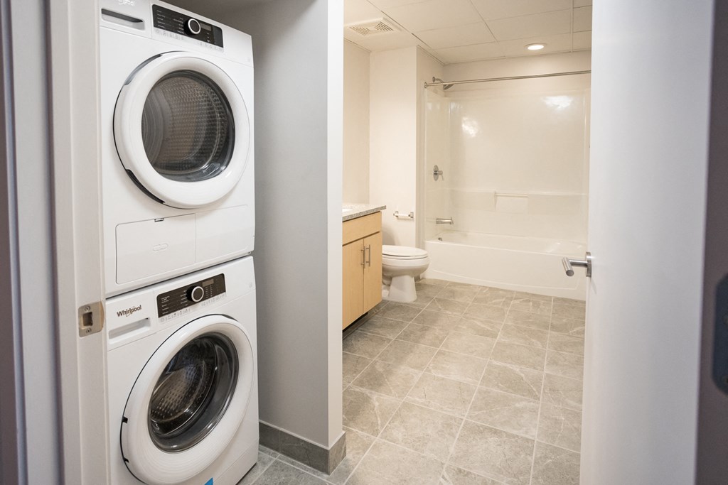 A white washing machine and dryer in a small laundry room.