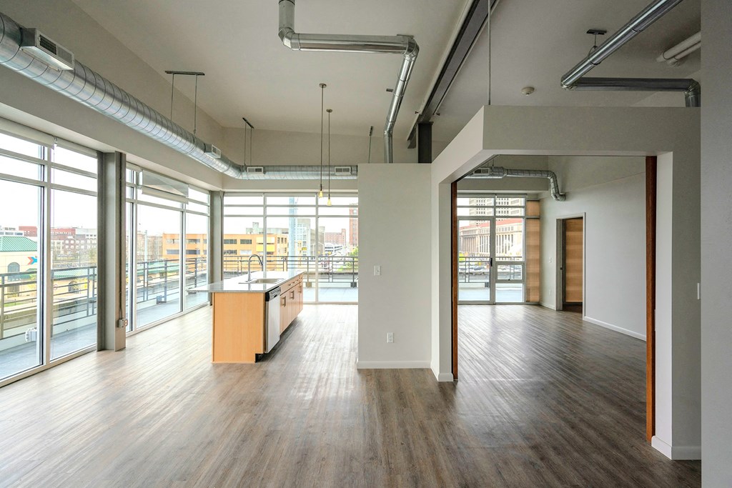 A large open room with wooden floors and white walls.