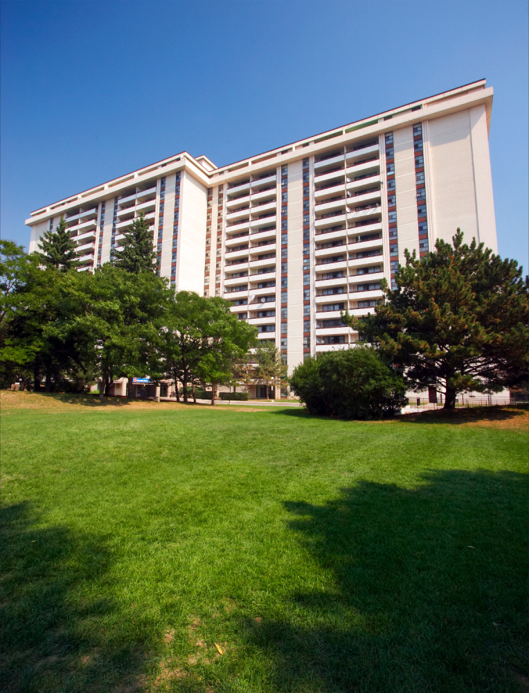 a large building in the middle of a green park