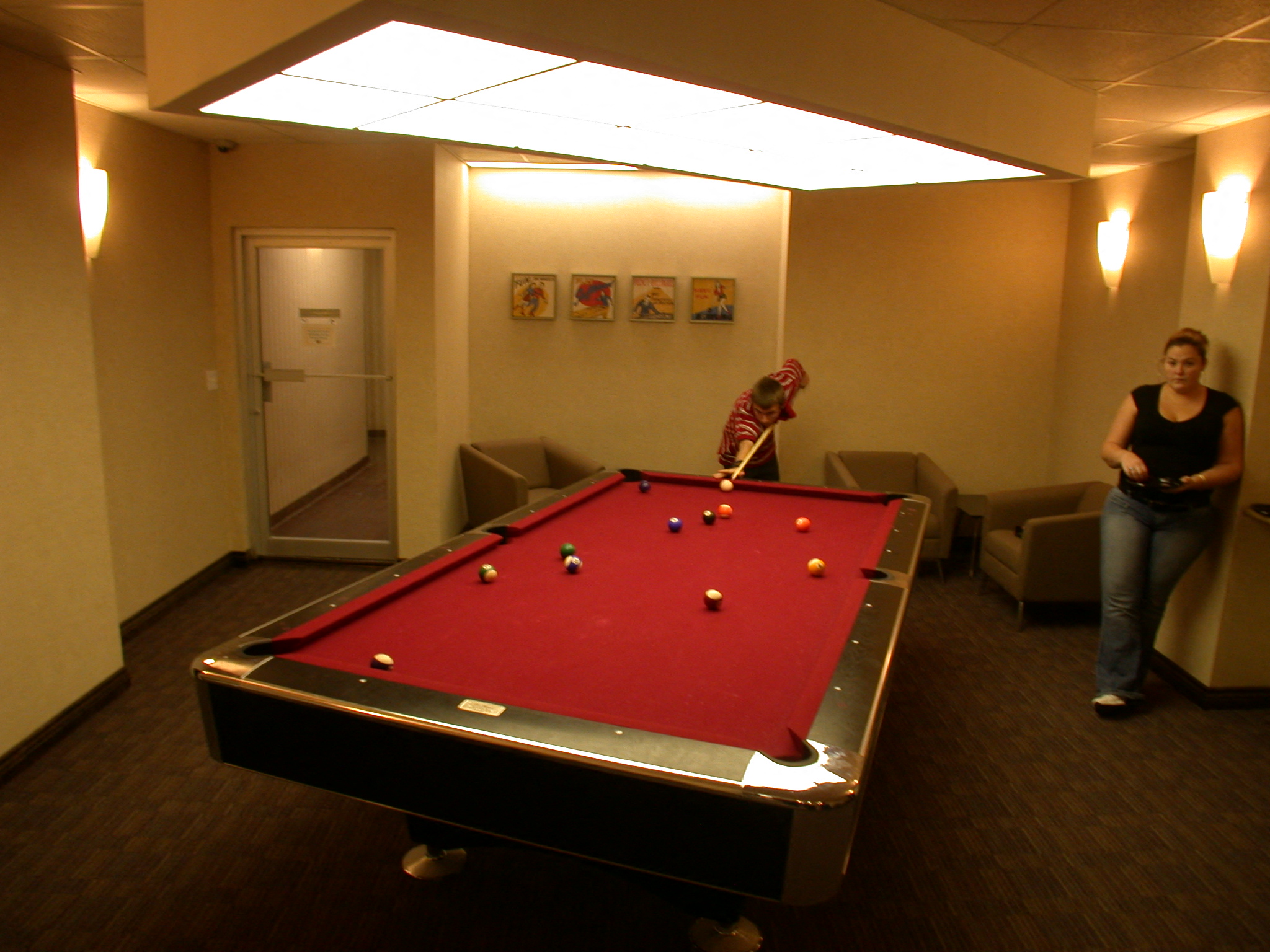a man playing a game of pool on a pool table