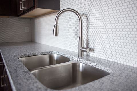 a kitchen sink with a faucet in a 555 waverly unit  at RoCo Apartments, North Dakota, 58102