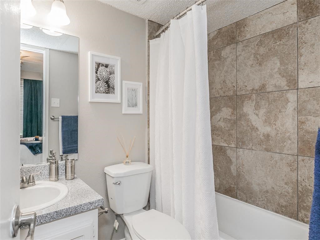 Contemporary bathroom with large mirror and modern lighting