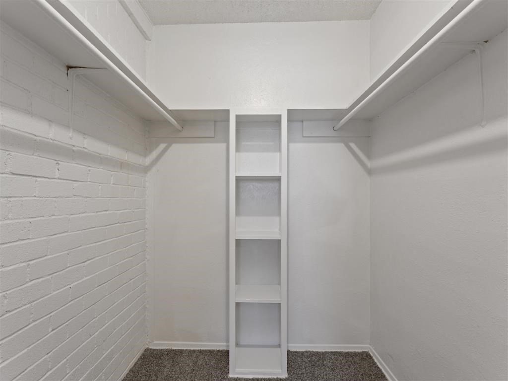 Full walk-in closet with built-in bookshelves