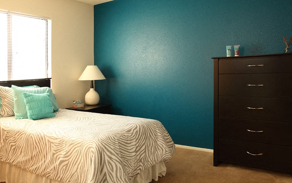 a bedroom with a bed and a dresser