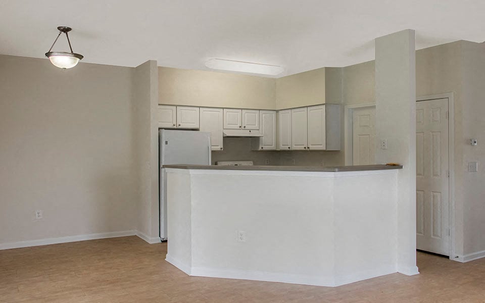 an empty kitchen with an island in the middle of it
