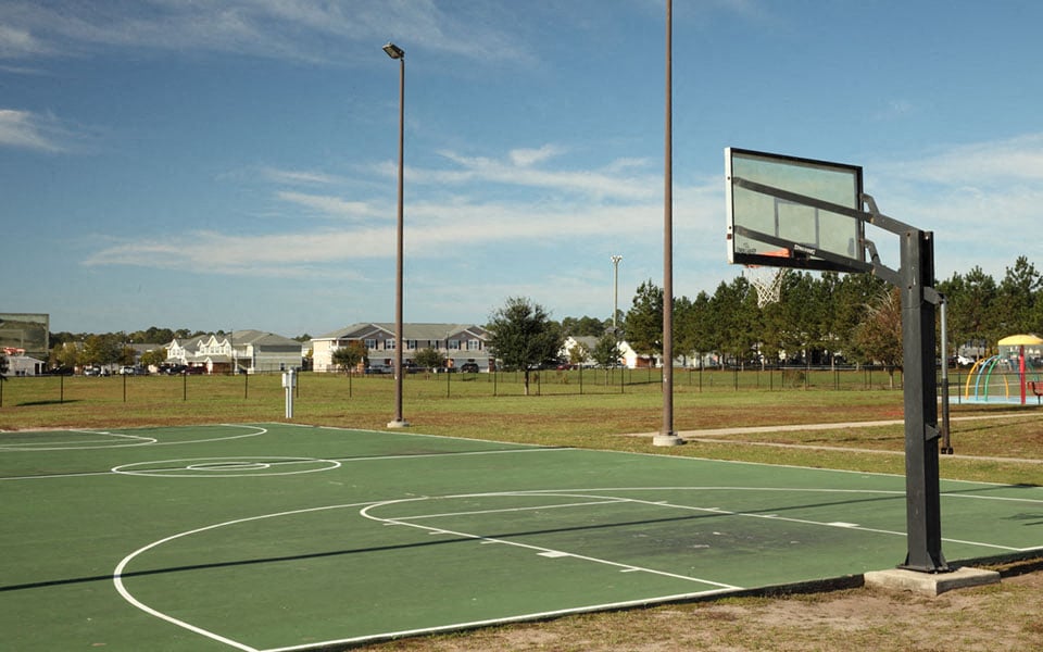 a basketball court in a park