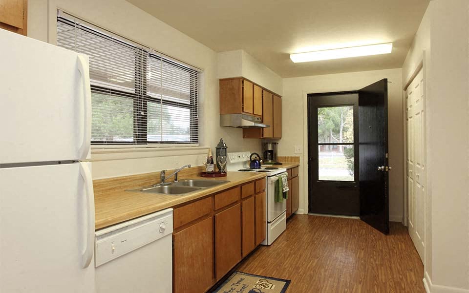 a kitchen with a sink and a refrigerator