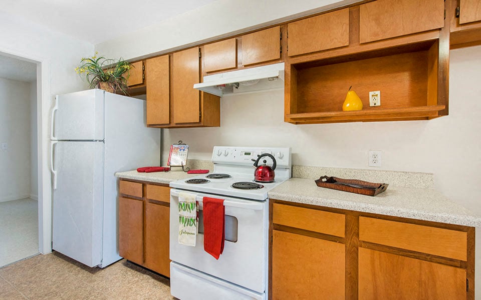 a kitchen with a white stove and a refrigerator