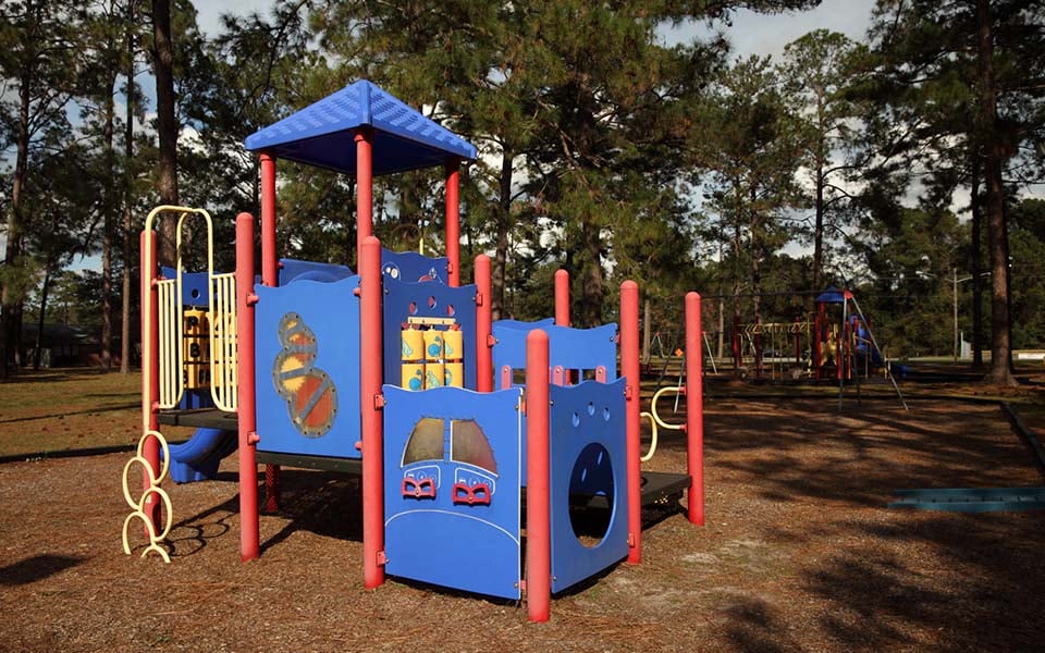 a colorful playground with a blue and red swing set