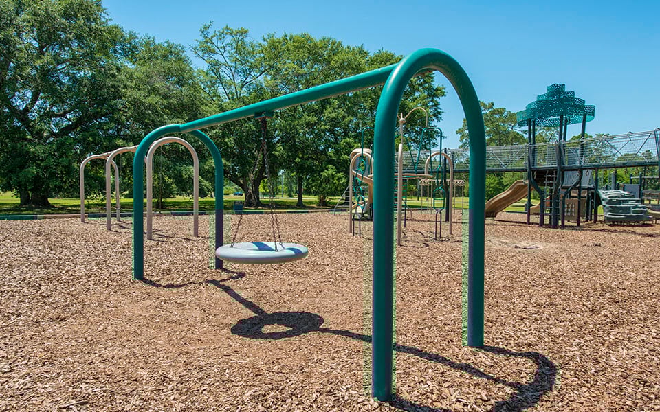 a swing set in the middle of a playground