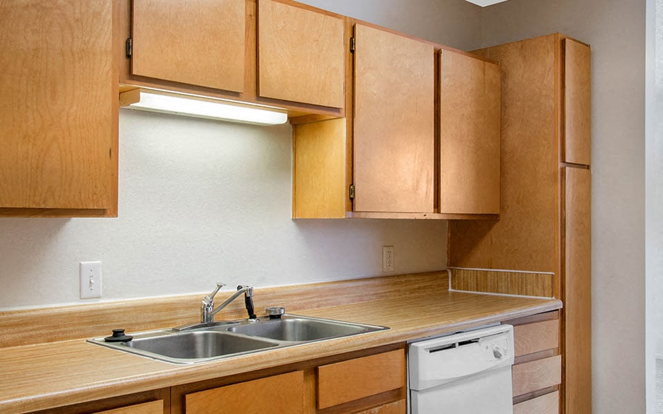 a kitchen with wooden cabinets and a sink