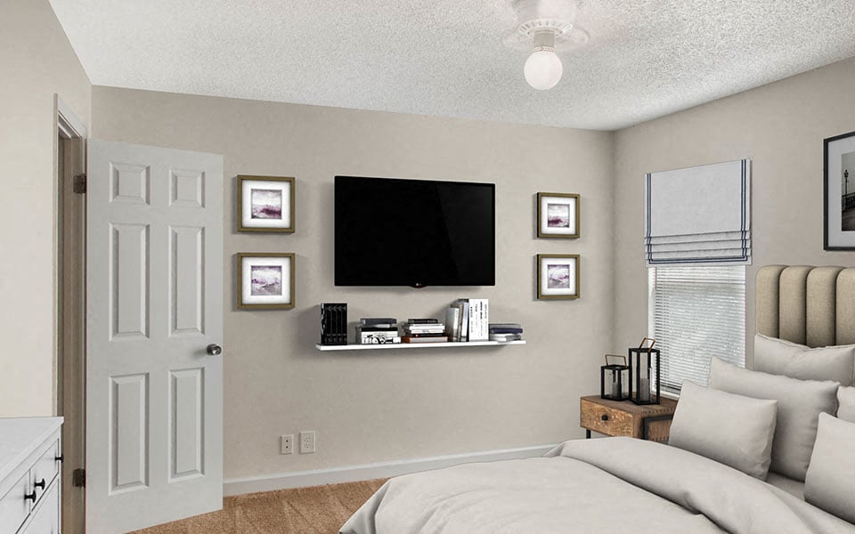 a bedroom with a tv on the wall and a bed