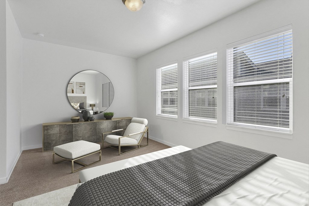 a bedroom with a large bed and a vanity with a mirror