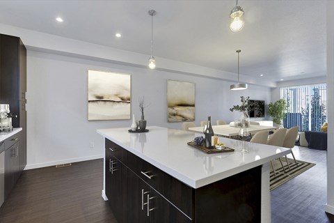 an open kitchen and living room with a table and chairs