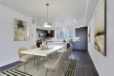 a dining room with a table and chairs and a kitchen