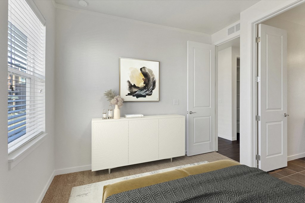 a bedroom with a bed and a white dresser