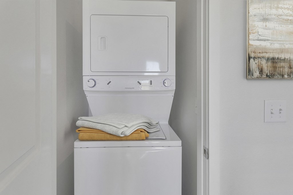 the washer and dryer in the laundry room of a white house