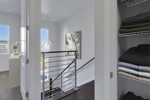 a bedroom with a staircase leading up to a room with a bunk bed