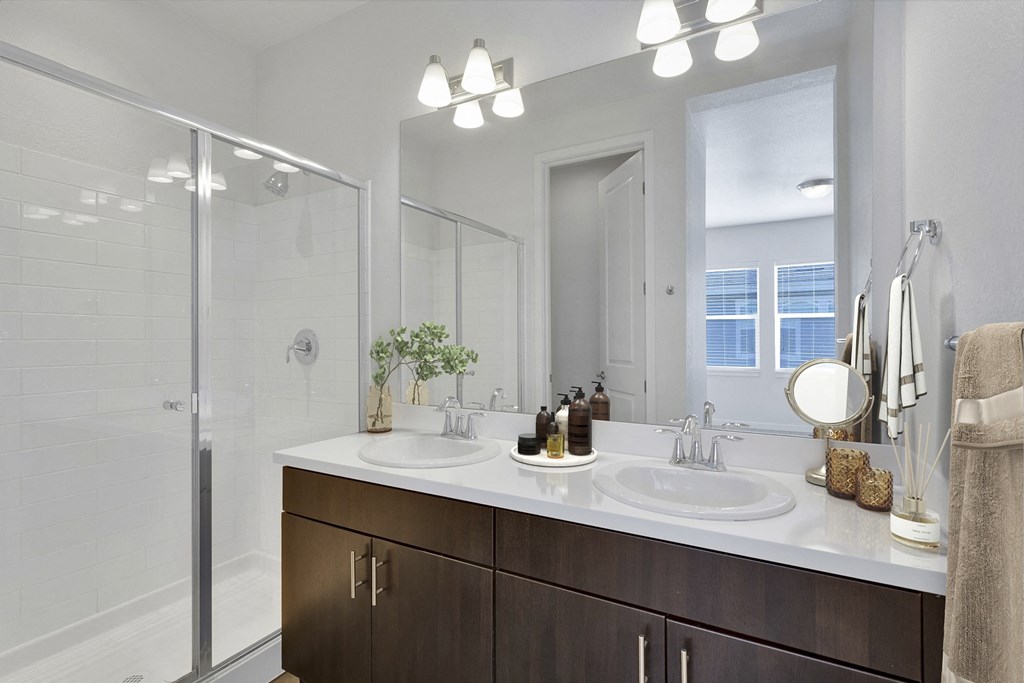 a bathroom with two sinks and a shower