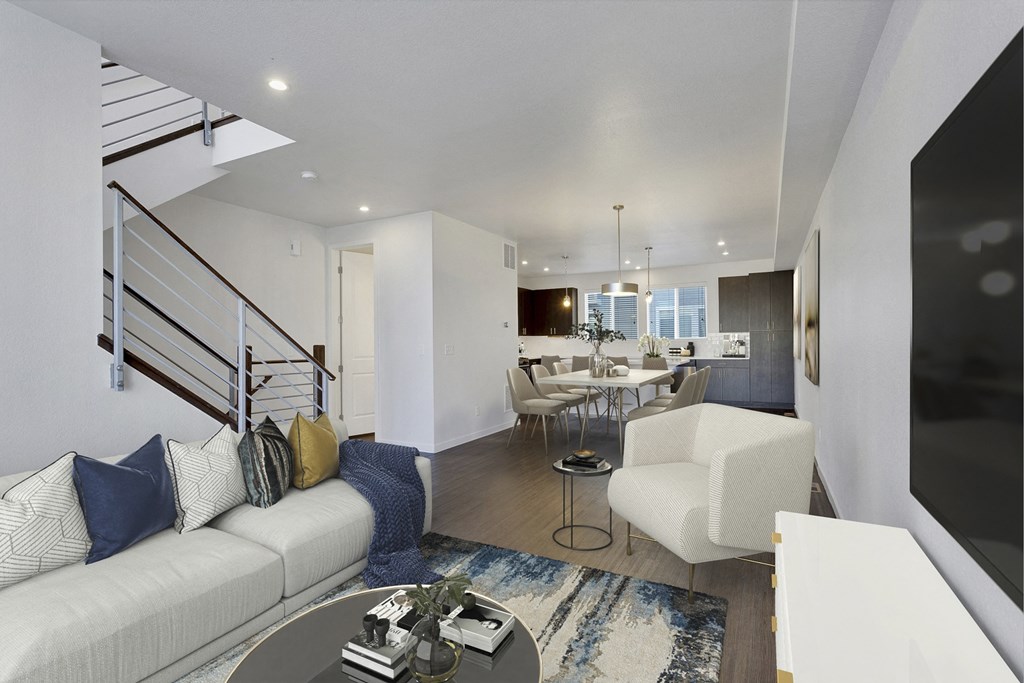 a living room with a white couch and a table with chairs