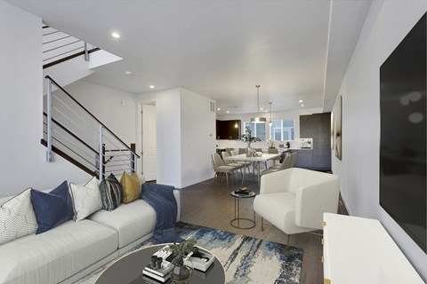 a living room with a white couch and a table with chairs