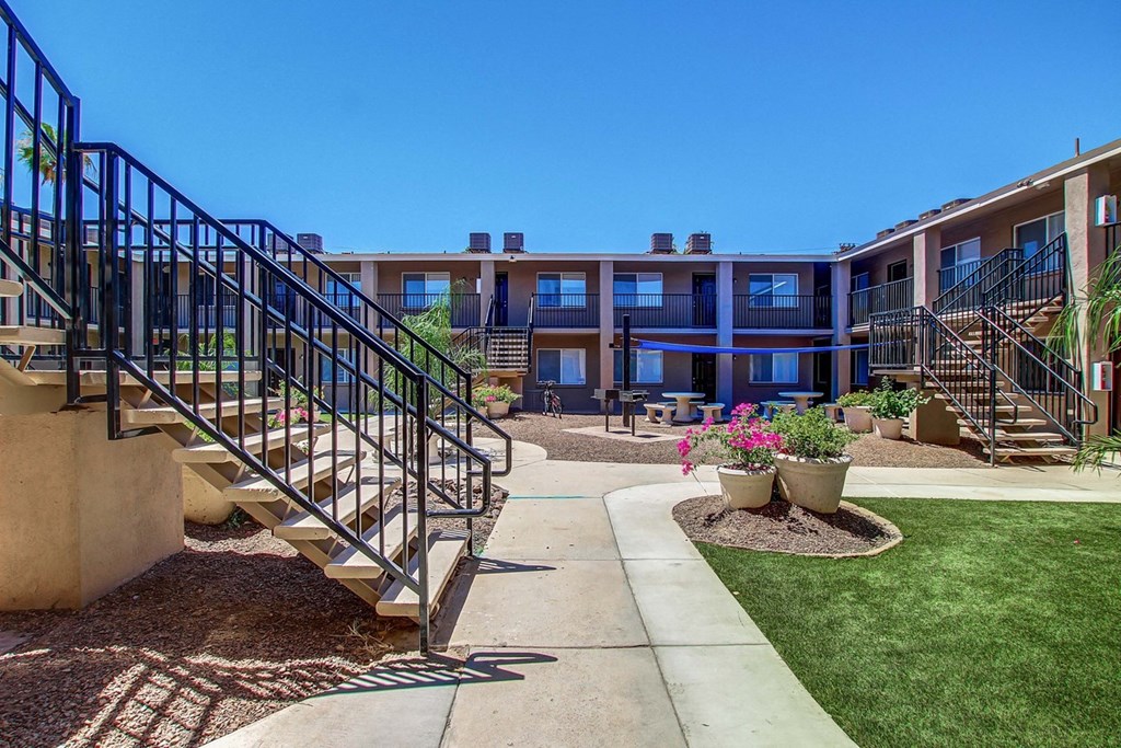 a view of a building with stairs and a courtyard