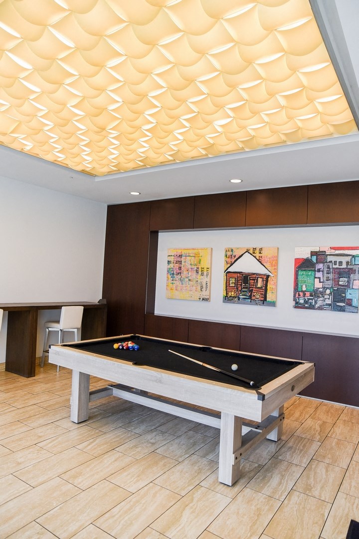 a pool table in a room with a ceiling covered in lights