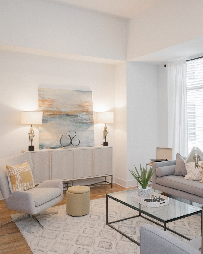 a living room with couches and a glass coffee table